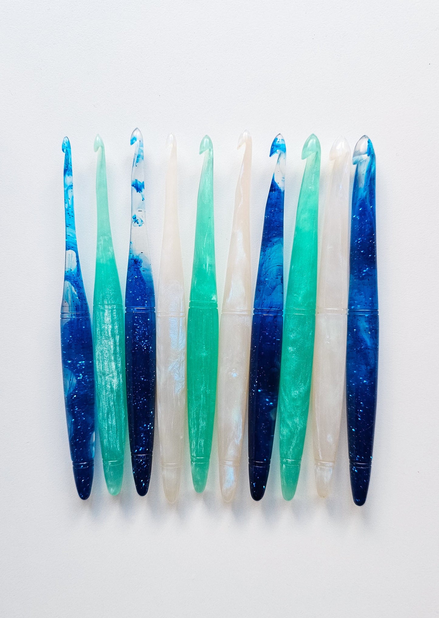 10 crochet hooks in three different variants, Sapphire, Aquamarine, and Opal.